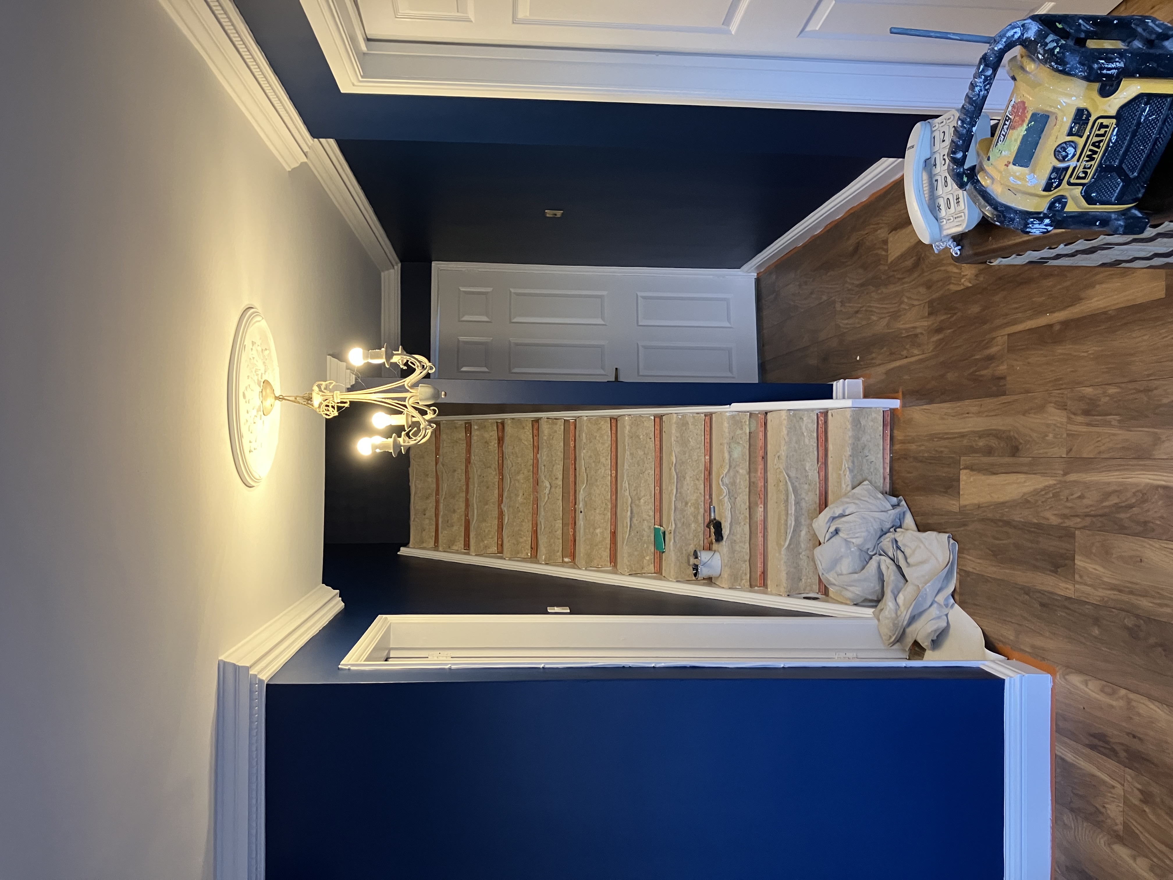Navy blue hallway with chandelier